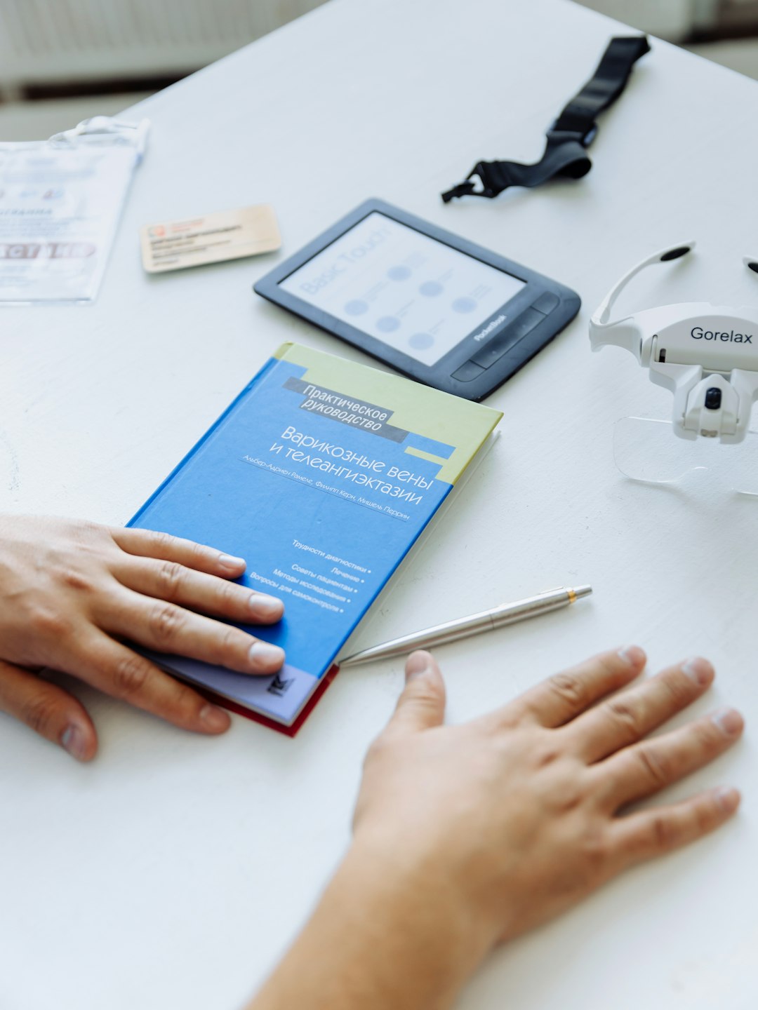 Services a-person-holding-a-book-near-a-remote-control-dydvm6bakxg