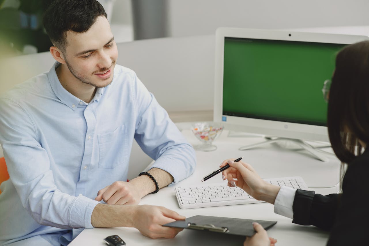 Services Colleagues discussing project details at a modern office desk